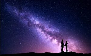 ζευγάρι κρατιέται από το χέρι αστέρια συμπαντική σύνδεση
