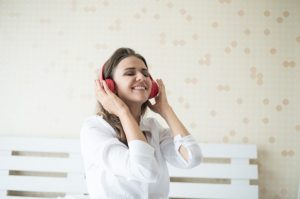 χαμογελαστή γυναίκα ακούει μουσική