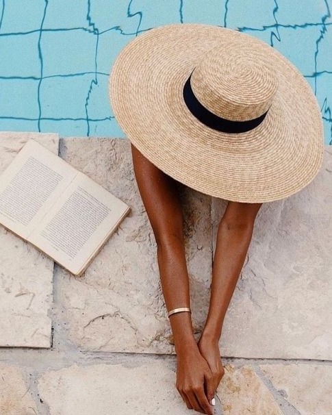 κοπέλα με ψάθινο καπέλο σε πισίνα - βαλίτσα διακοπών